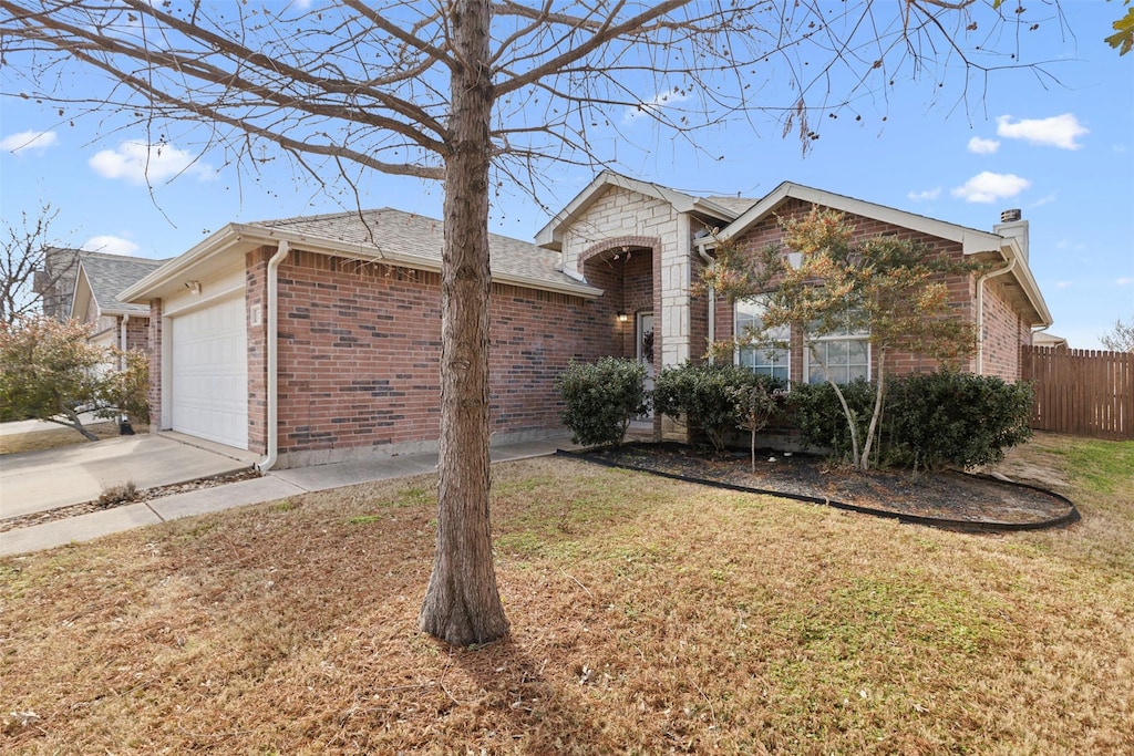 ranch-style house featuring a garage and a front yard