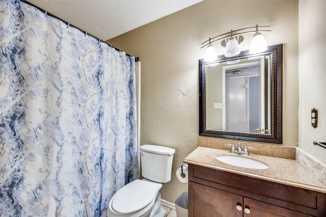 bathroom with a shower with curtain, vanity, toilet, and a textured ceiling