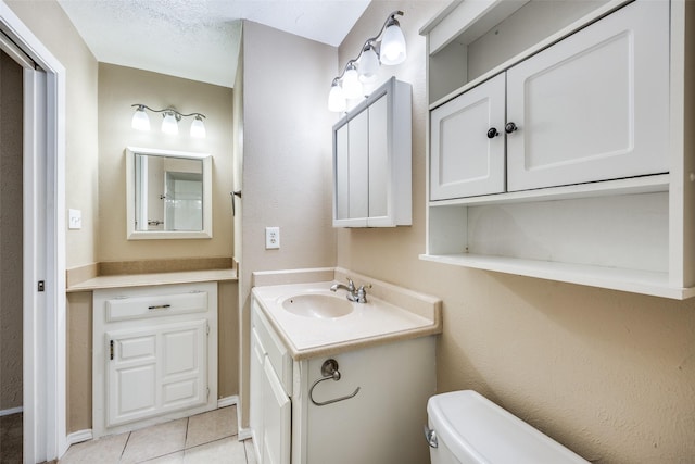 bathroom featuring vanity, toilet, and tile patterned flooring