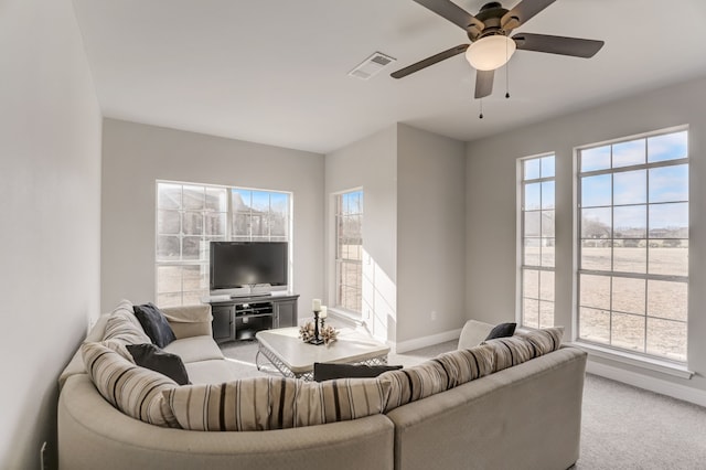 carpeted living room featuring ceiling fan