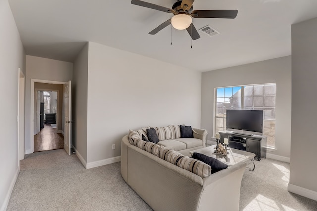 living room featuring light colored carpet and ceiling fan