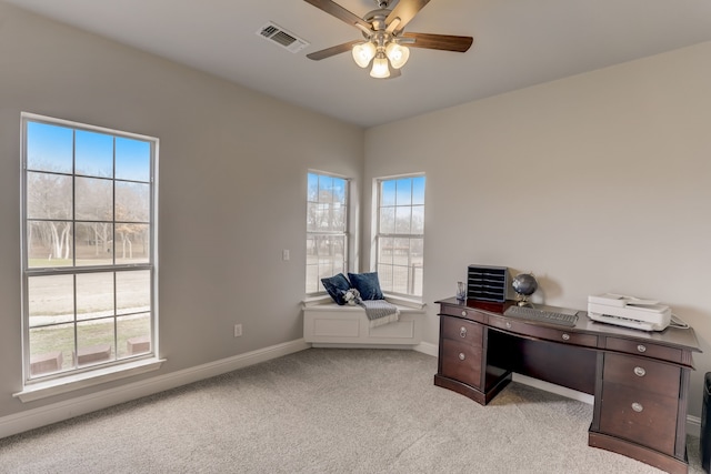 office area featuring a wealth of natural light, light colored carpet, and ceiling fan