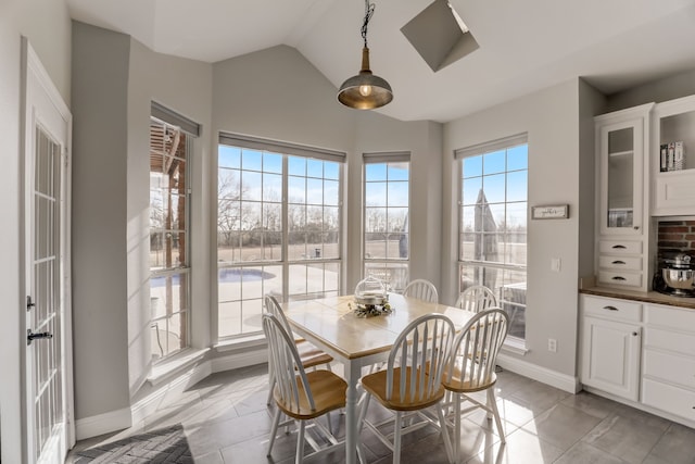 dining room featuring lofted ceiling