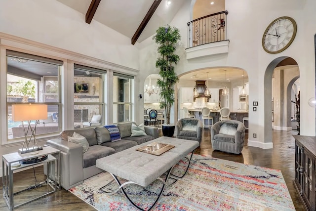 7281 Shingle Mill Rd, Frisco, TX 75036 - living room with arched walkways, beam ceiling, wood finished floors, high vaulted ceiling, and a chandelier