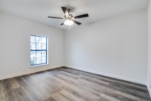 empty room featuring ceiling fan, hardwood / wood-style flooring, and a textured ceiling