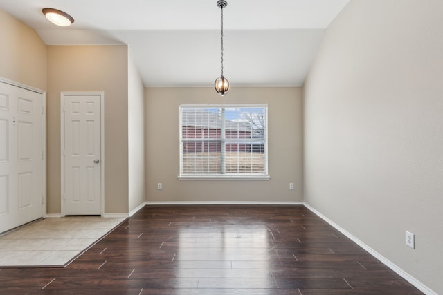 unfurnished dining area with vaulted ceiling