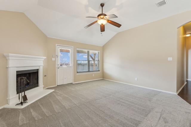 unfurnished living room with lofted ceiling, carpet floors, and ceiling fan