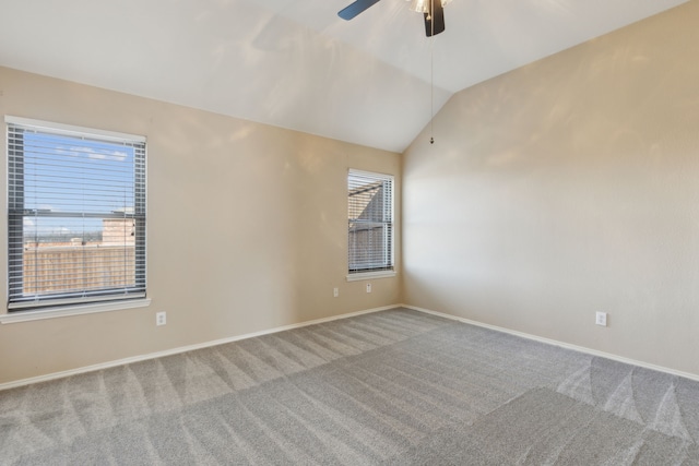 carpeted empty room featuring lofted ceiling and ceiling fan