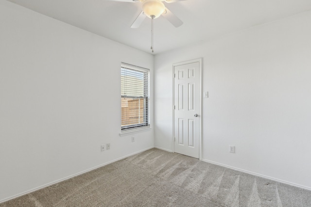 empty room with ceiling fan and carpet flooring