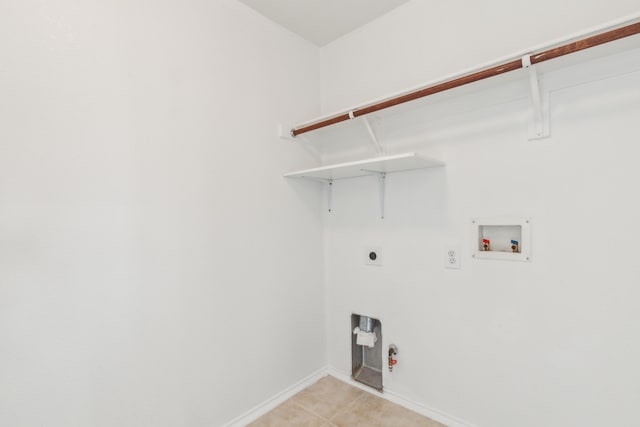 clothes washing area featuring gas dryer hookup, light tile patterned floors, hookup for a washing machine, and electric dryer hookup