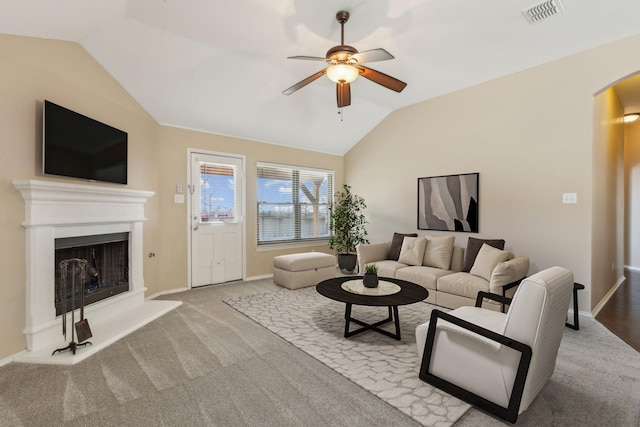 carpeted living room featuring vaulted ceiling and ceiling fan