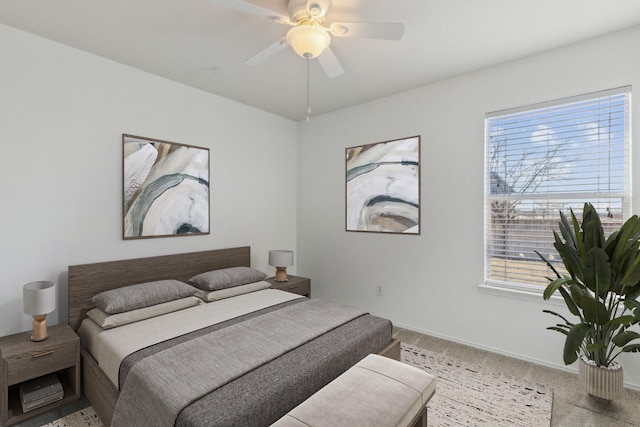 bedroom with ceiling fan, carpet flooring, and multiple windows