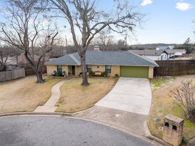 ranch-style home with a garage and a front lawn