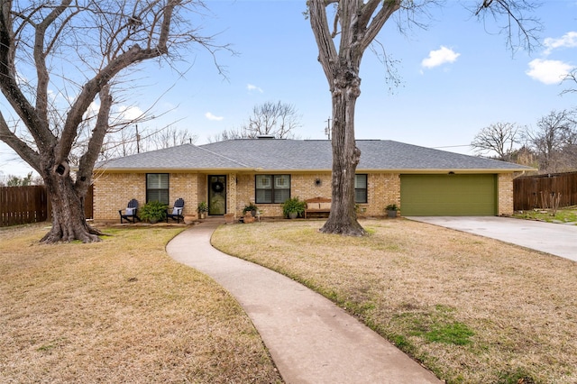 ranch-style house featuring a garage and a front lawn