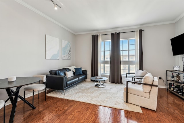 living room featuring hardwood / wood-style flooring, crown molding, and rail lighting