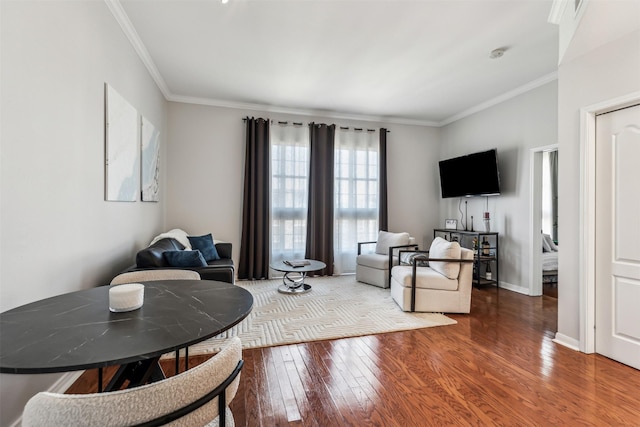 living room featuring ornamental molding and wood-type flooring