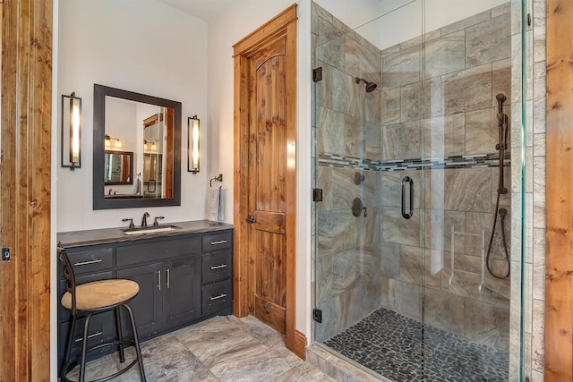 bathroom featuring vanity and a shower with shower door