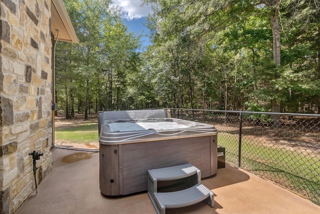 view of patio / terrace with a hot tub