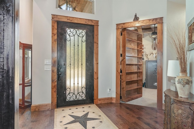 entryway with dark hardwood / wood-style floors and a high ceiling