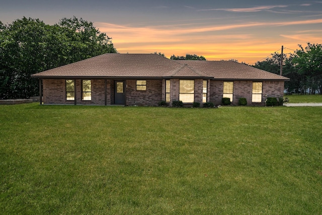 ranch-style house featuring a yard