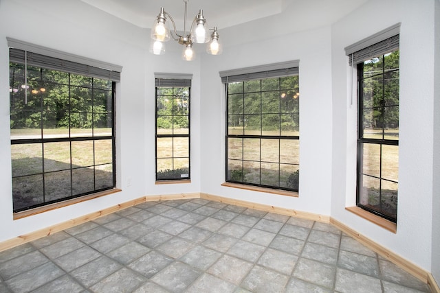 unfurnished dining area featuring an inviting chandelier