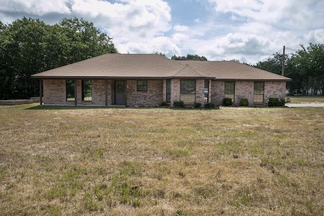 ranch-style home featuring a front yard