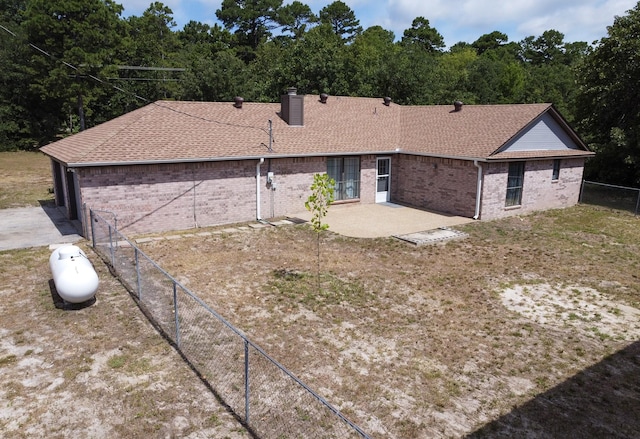 2048 County Road 3540, Hawkins, TX 75765 - ranch-style house with roof with shingles, a chimney, fence, brick siding, and a patio area
