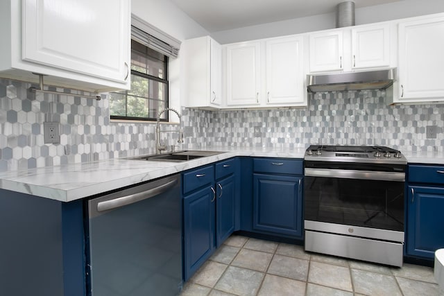 kitchen with blue cabinetry, stainless steel appliances, sink, and white cabinets