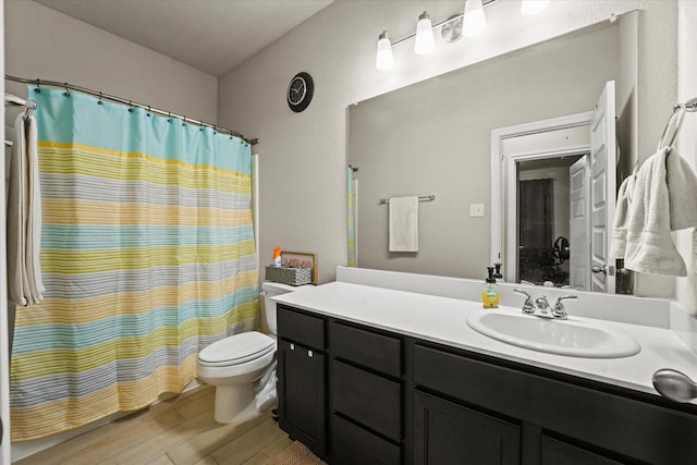 bathroom featuring wood finished floors, toilet, vanity, and a shower with curtain