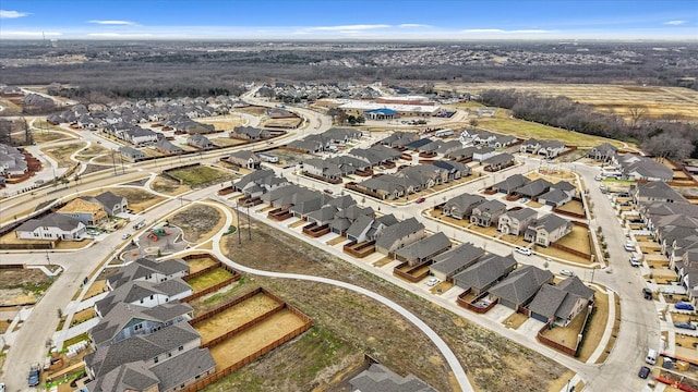 aerial view of property and surrounding area featuring nearby suburban area