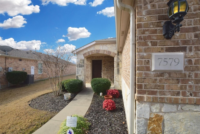 view of exterior entry with central AC unit