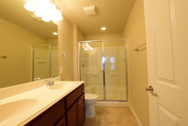 bathroom with tile patterned flooring, vanity, toilet, and walk in shower