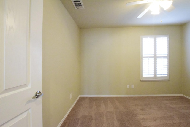 unfurnished room featuring ceiling fan and carpet