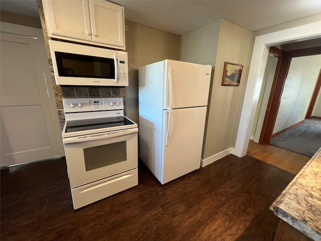 kitchen featuring white appliances, dark hardwood / wood-style floors, and white cabinets