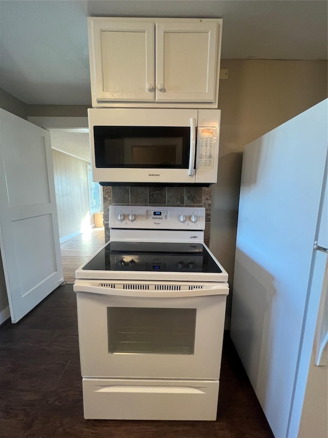 kitchen featuring white cabinetry, white appliances, dark hardwood / wood-style flooring, and tasteful backsplash