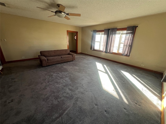 unfurnished living room featuring ceiling fan, carpet flooring, and a textured ceiling