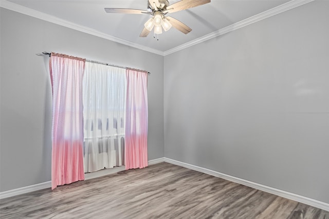 empty room featuring hardwood / wood-style flooring, ornamental molding, and ceiling fan