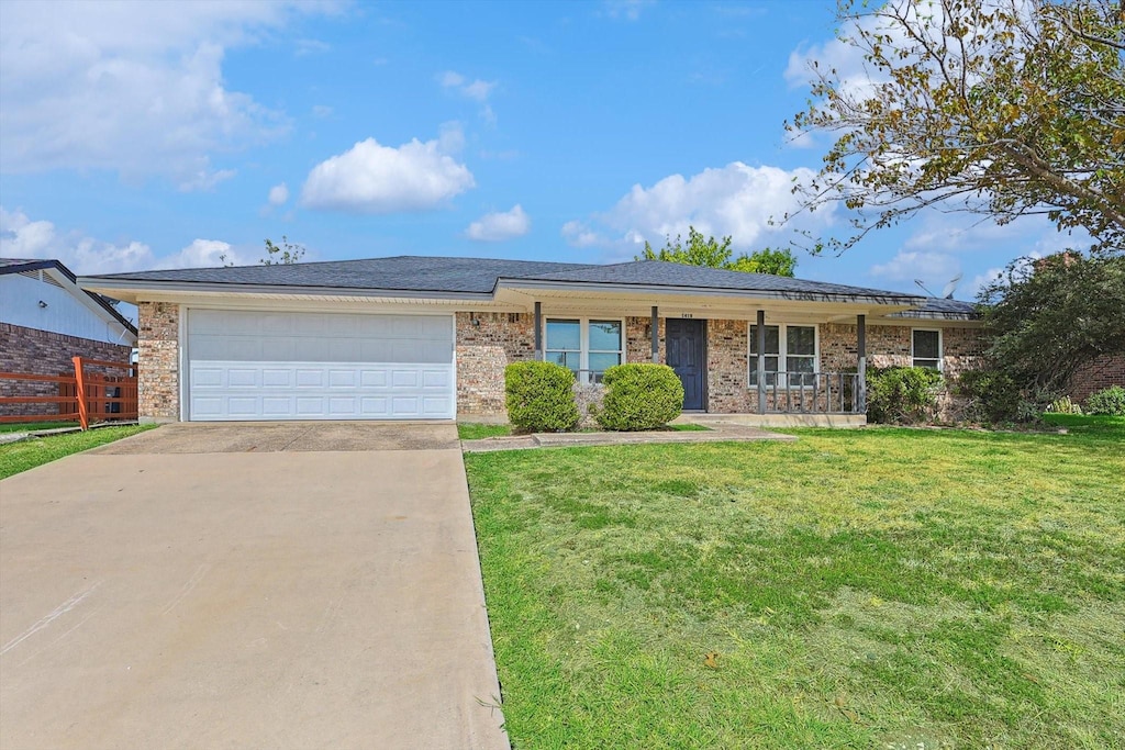 ranch-style house with a garage and a front yard