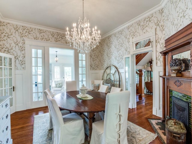 dining area with dark hardwood / wood-style flooring, a notable chandelier, and crown molding