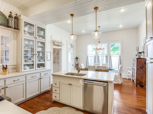 kitchen featuring decorative light fixtures, dishwasher, sink, dark wood-type flooring, and a center island with sink