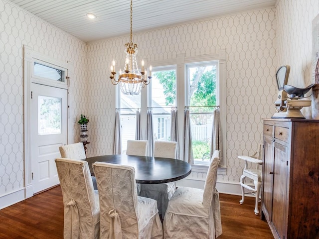 dining space with dark hardwood / wood-style flooring and a chandelier