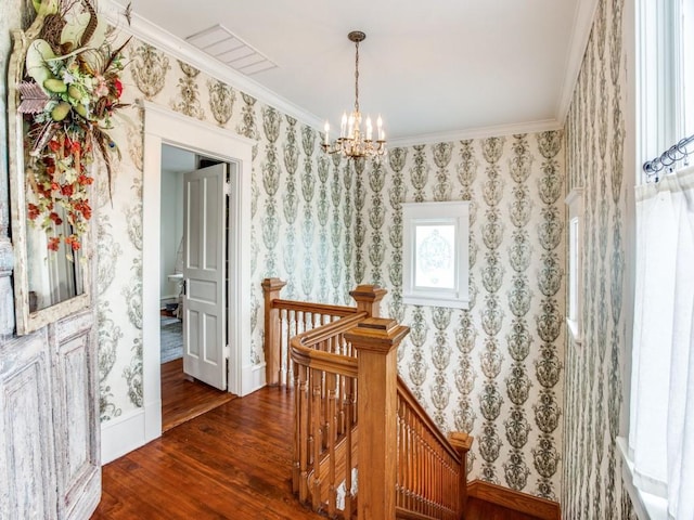 hall featuring dark hardwood / wood-style flooring, a notable chandelier, and crown molding