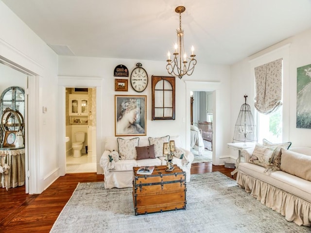 sitting room featuring an inviting chandelier and dark hardwood / wood-style flooring