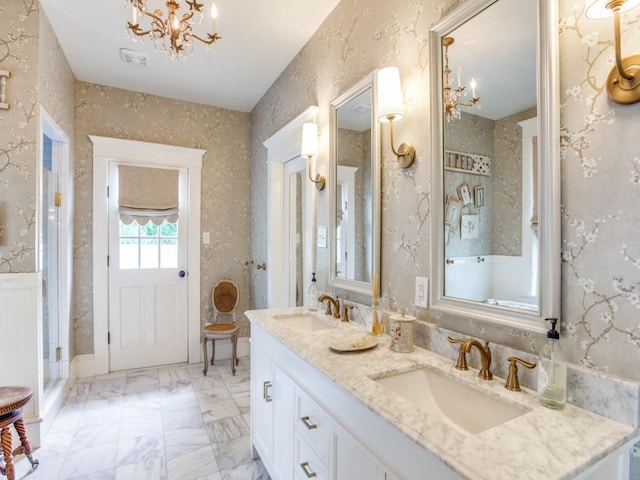 bathroom featuring vanity and a notable chandelier