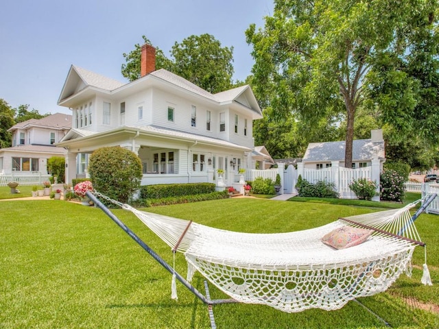 rear view of house with a lawn