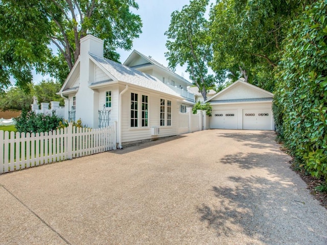 view of front of home with a garage and an outdoor structure