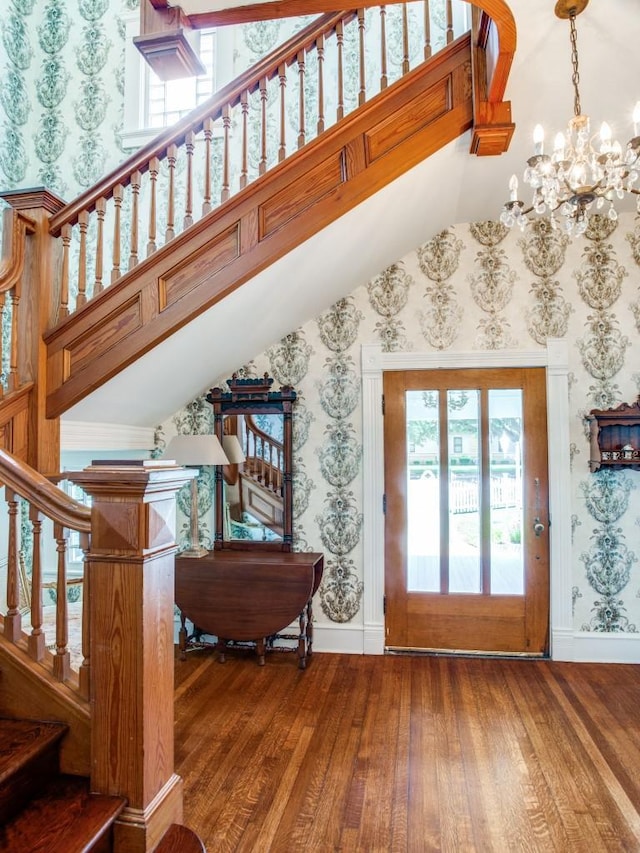 entryway featuring hardwood / wood-style floors and a notable chandelier