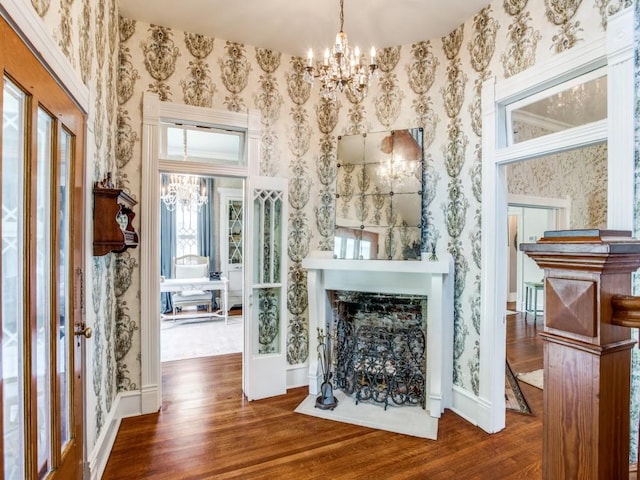 interior space with an inviting chandelier and dark hardwood / wood-style floors