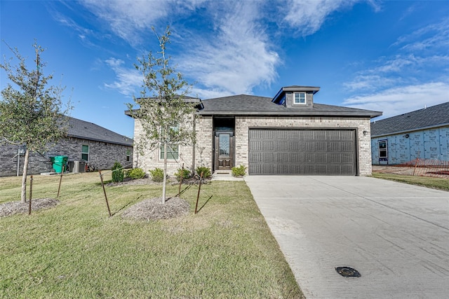 view of front of home with a garage and a front yard