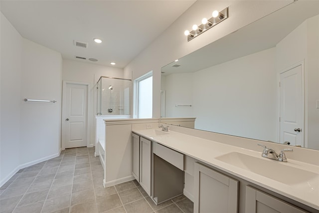 bathroom featuring shower with separate bathtub, vanity, and tile patterned floors